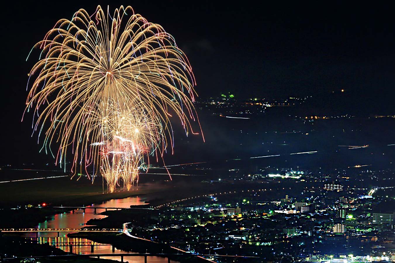Aerial view of fireworks over Toyooka and the Maruyama river