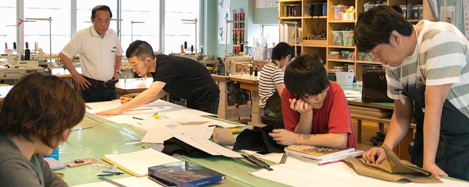 A bunch of Toyooka craftsman planning together in a workshop